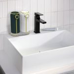 soap dispenser with tray in bathroom